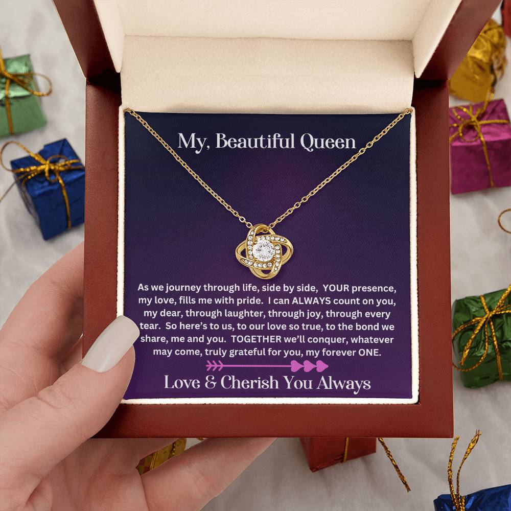 Hand holding Soulmate gift with love knot necklace and special message in luxury box