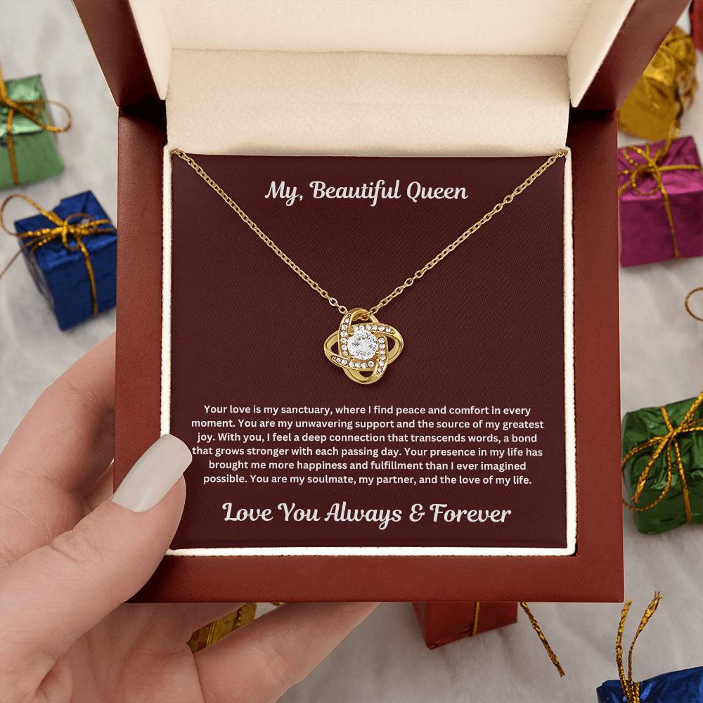 Hand holding Soulmate Gift with love knot necklace and special message in luxury box
