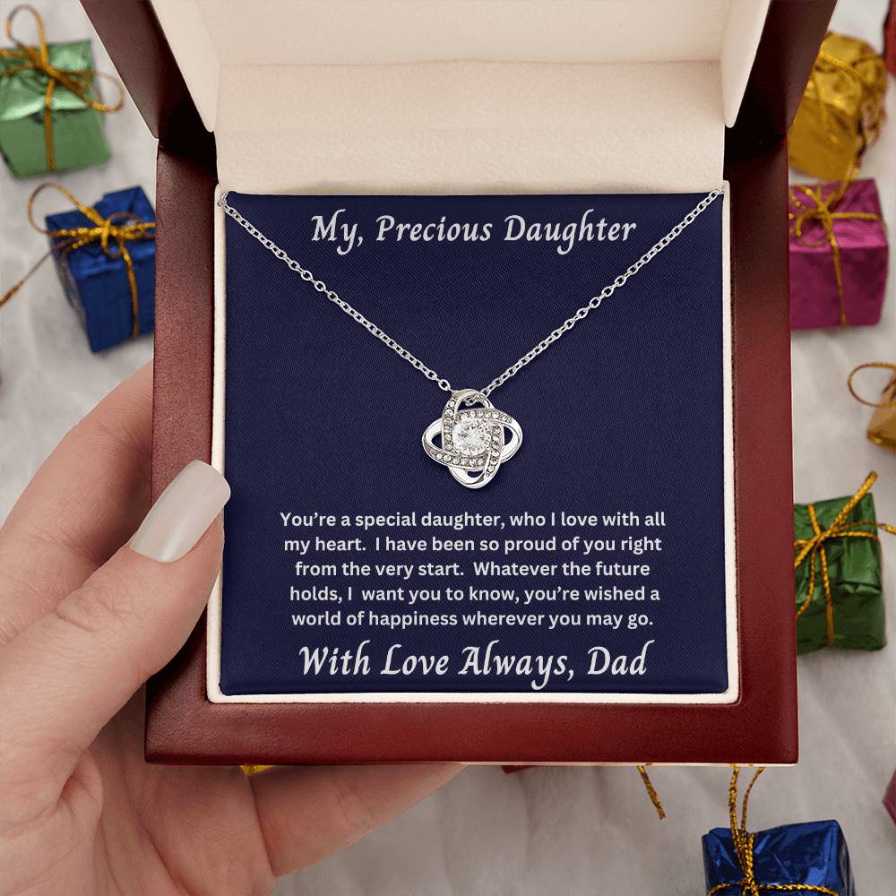 Hand holding Daughter gift from dad with love knot necklace and special message in luxury box