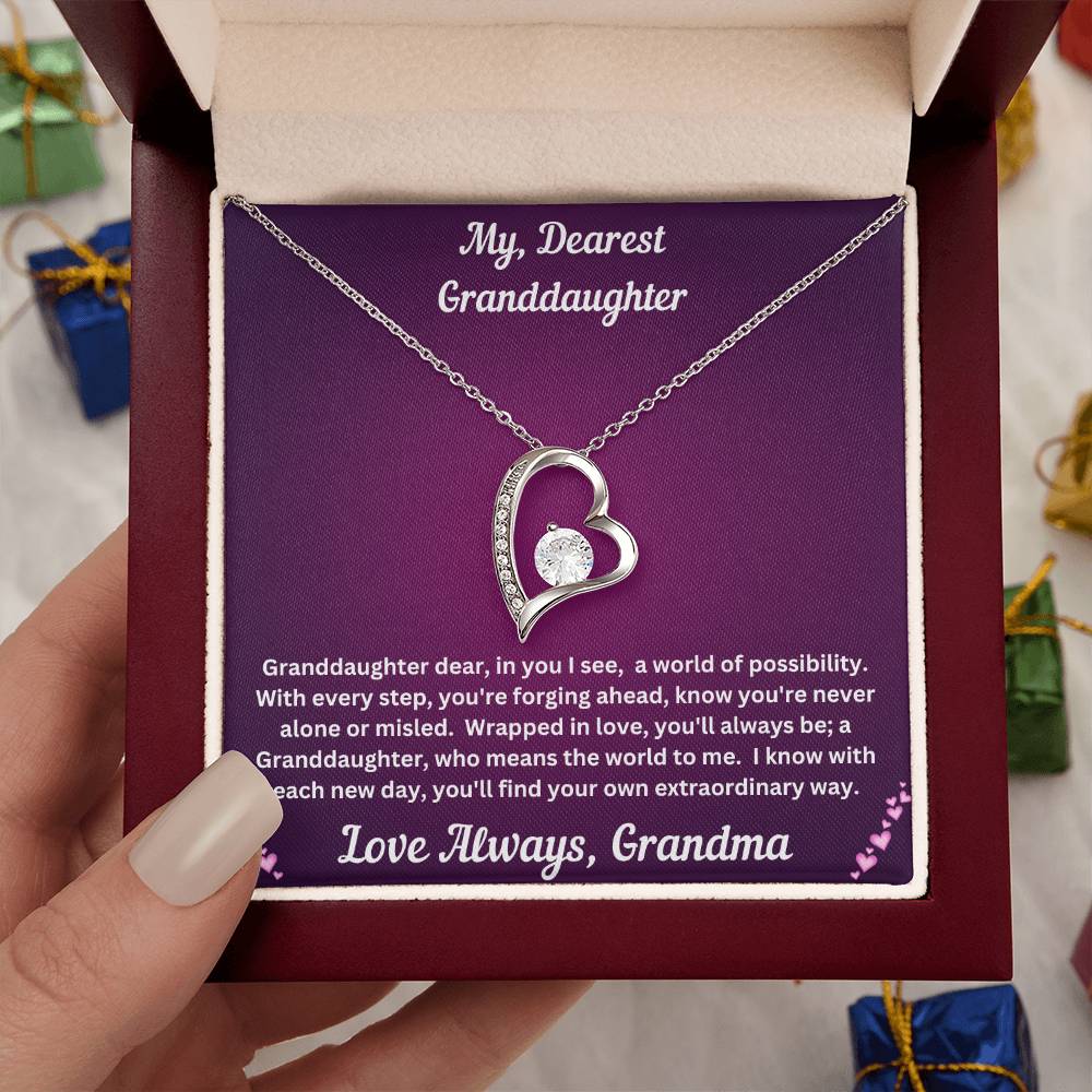 Hand holding Granddaughter gift from grandma with forever love necklace and special message in luxury box