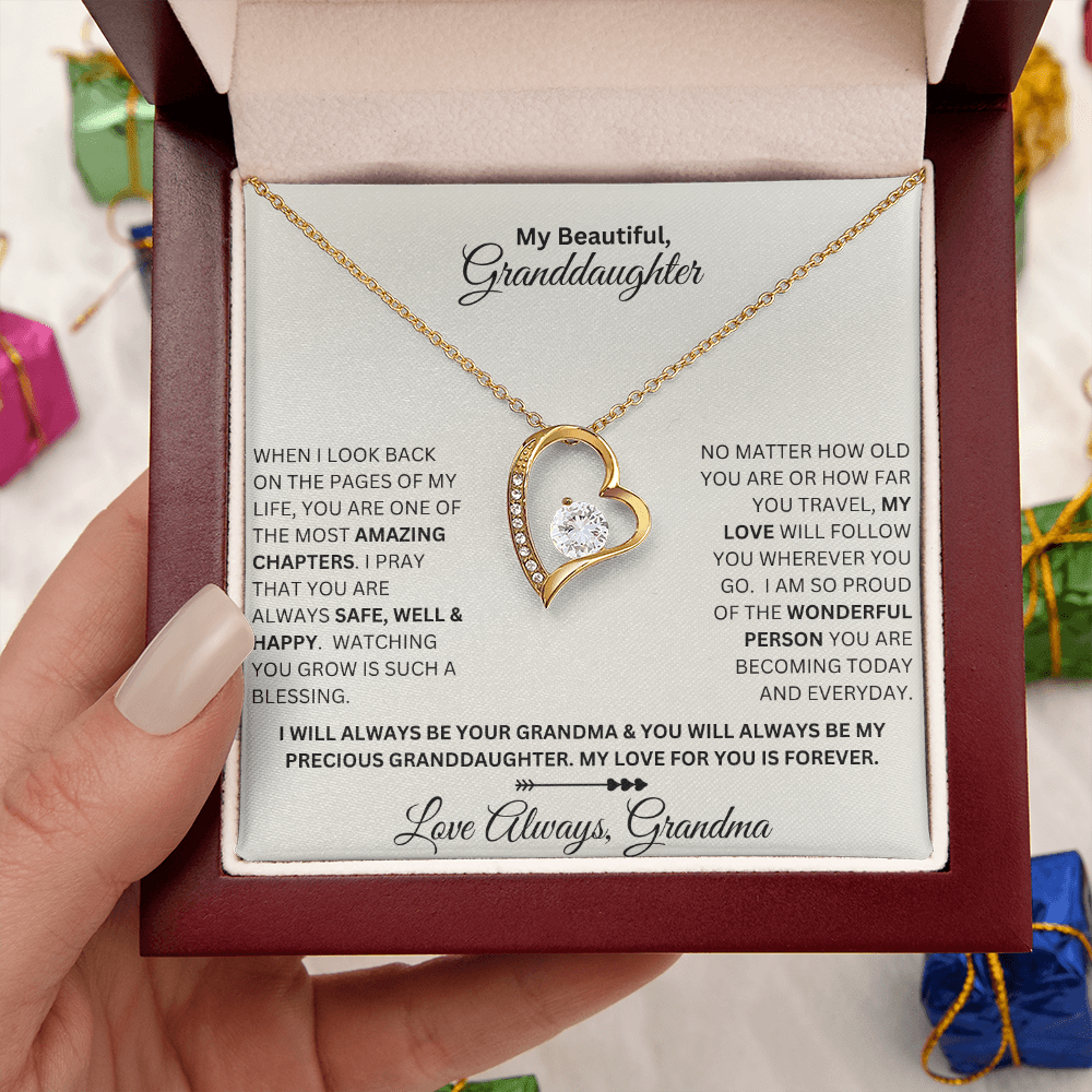 Hand holding Granddaughter gift from grandma with forever love necklace and special sentiment in a luxury box