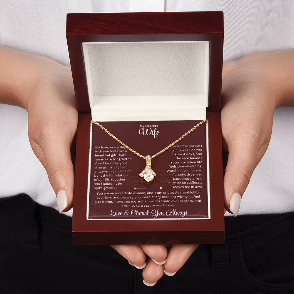 Two hand holding Wife gift with alluring beauty necklace and special sentiment in a luxury box