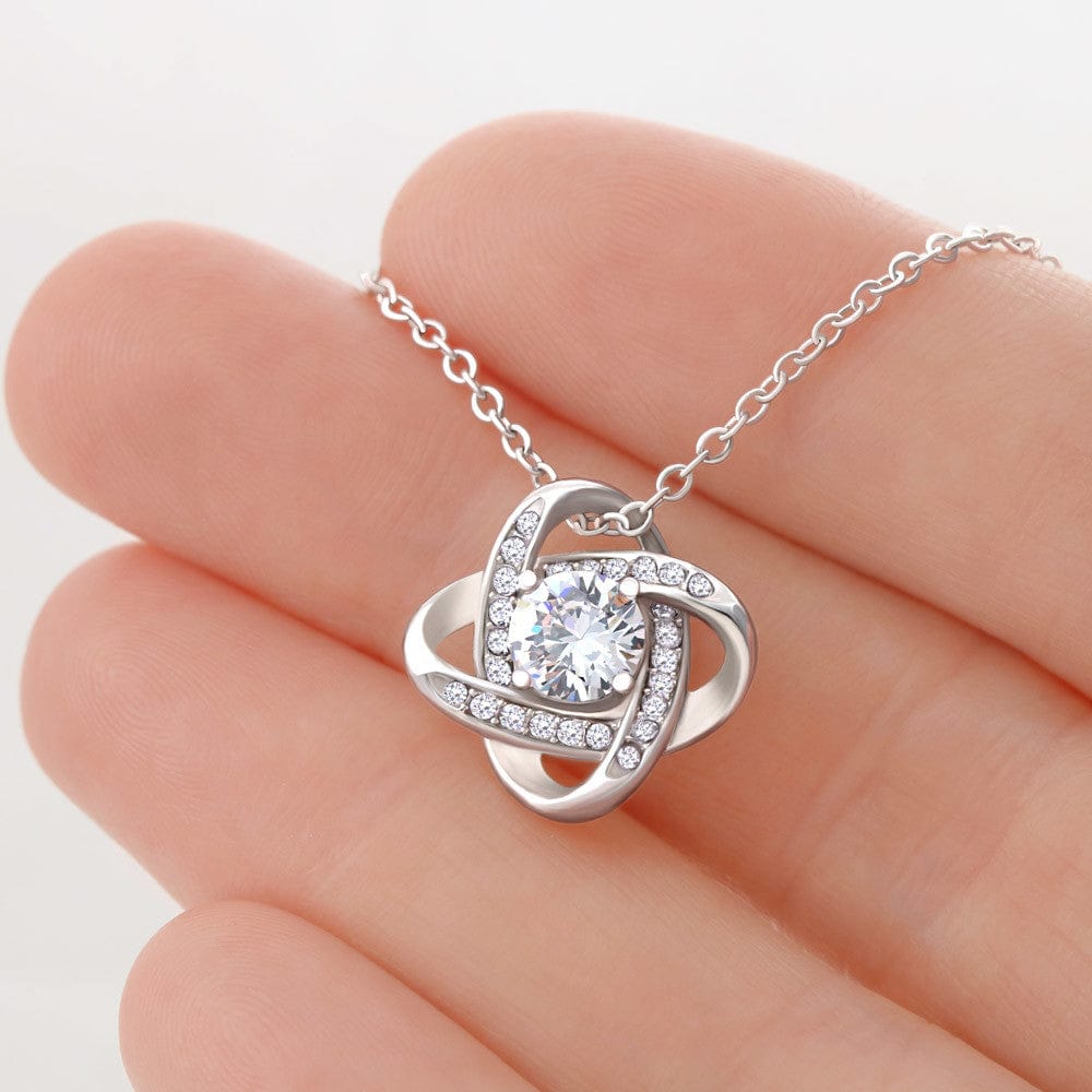 Very close view of love knot necklace in 14K white gold finish