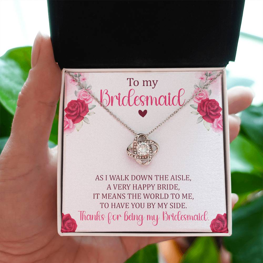 Hnad holding Bridesmaid gift with love knot necklace and special message in ready to gift box