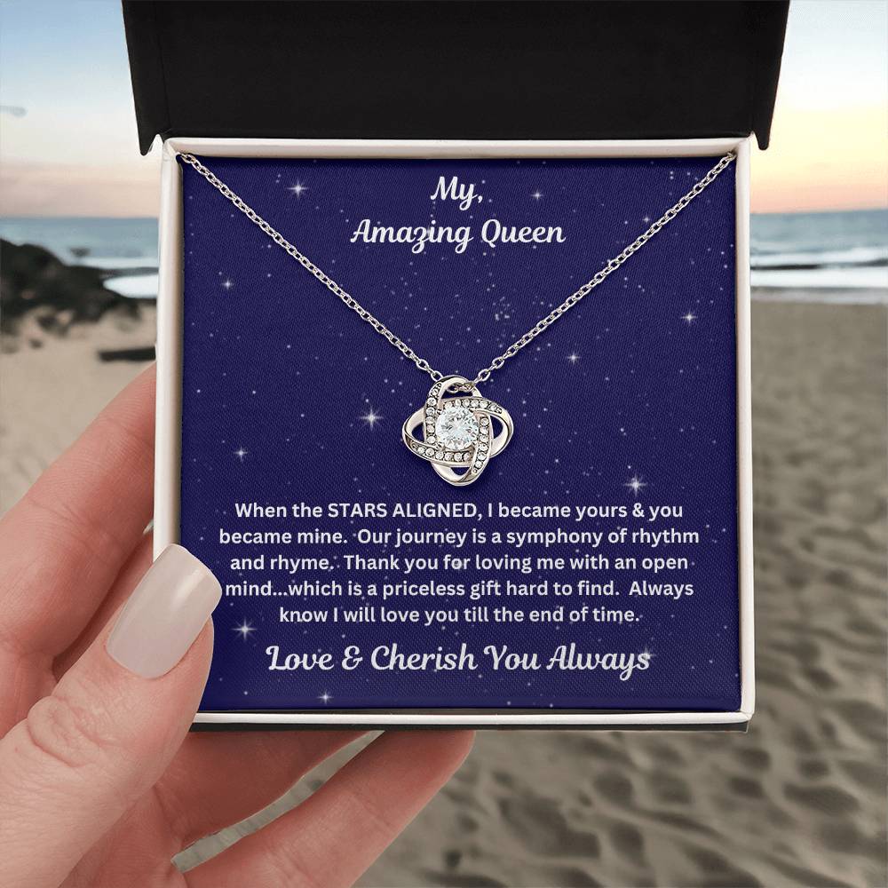 Hand holding the Soulmate gift with Love Knot Necklace and special message in standard box