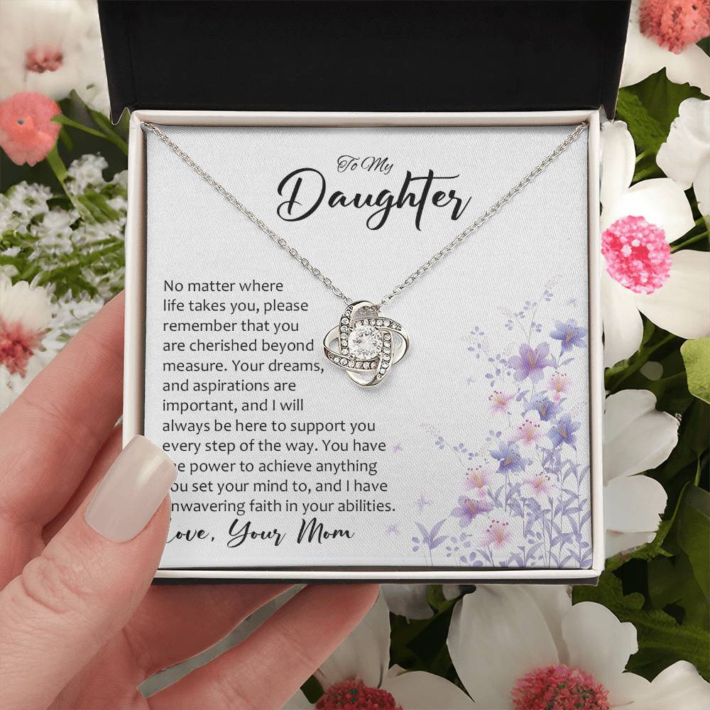 Hand Holding Daughter gift from mom with love knot necklace with special message in two tone box