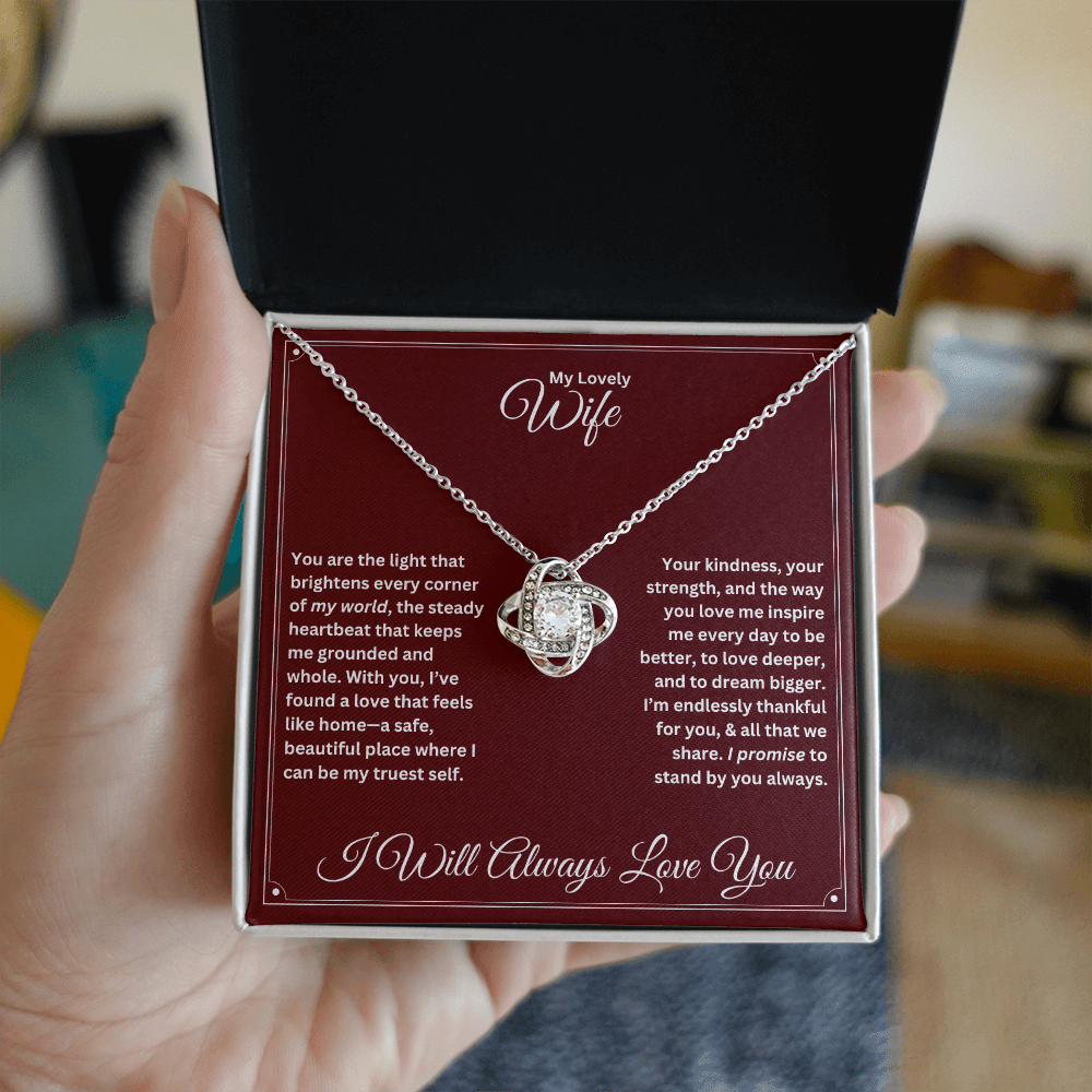 Hand holding Wife gift with love knot necklace and special message in a standard box