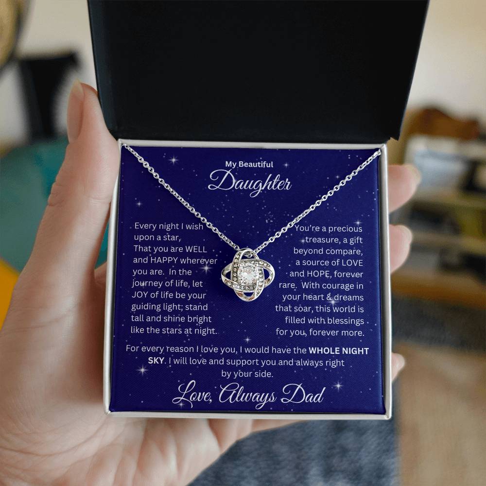 Hand holding Daughter gift from dad with love knot necklace and special message in a ready to gift box