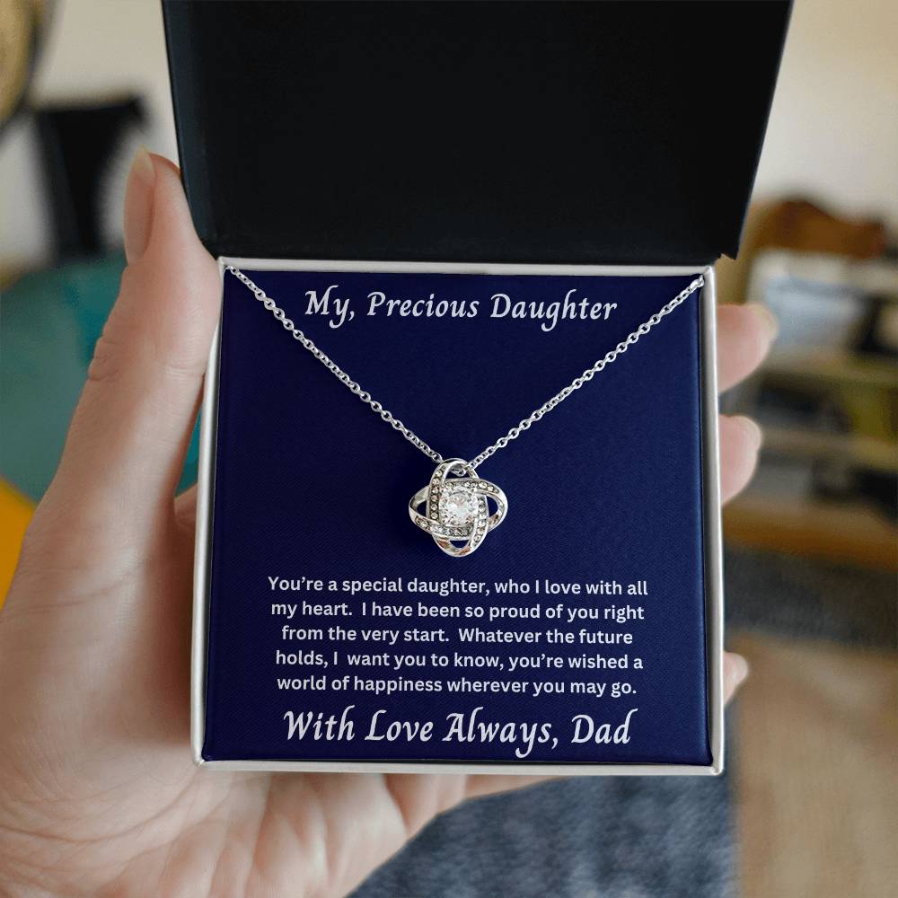 Hand holding Daughter gift from dad with love knot necklace and special message in two tone box