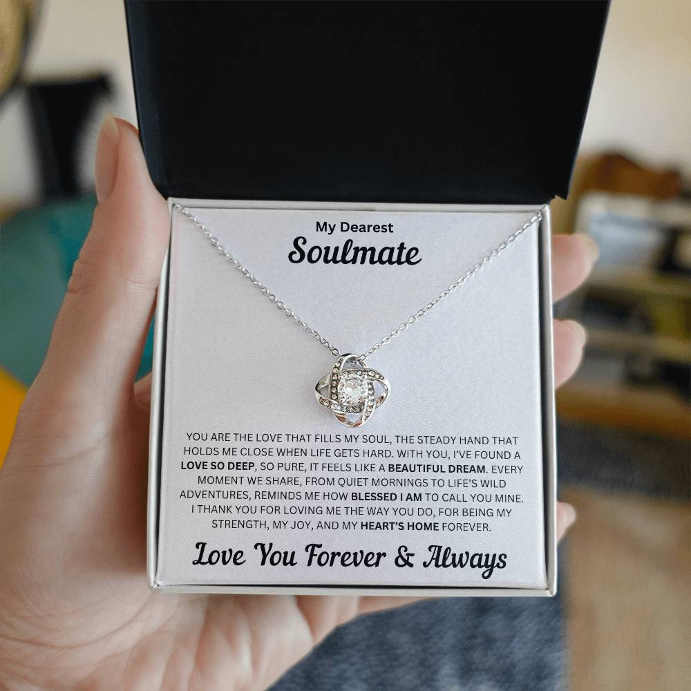 Hand holding Soulmate gift with love knot necklace and special message in a standard box