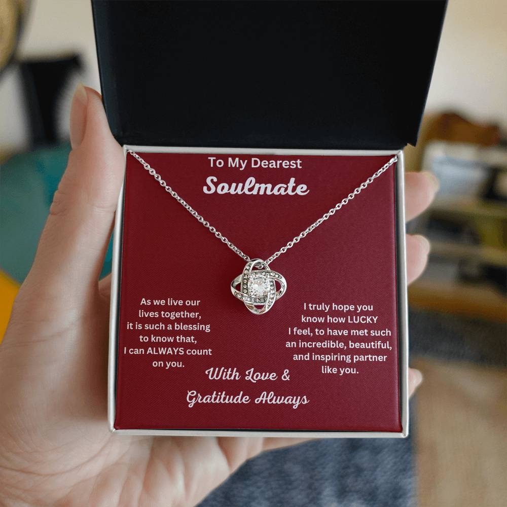 Hand Holding Soulmate Gift-Love Knot Necklace In Polished Stainless Steel In Two Toned Box With Message Card