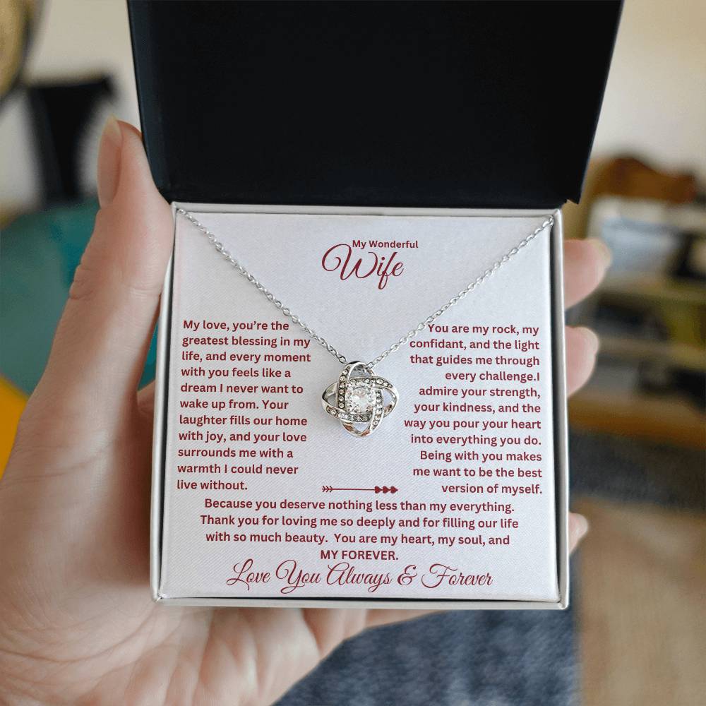 Hand holding Wife Gift with love knot necklace and special message in a standard box