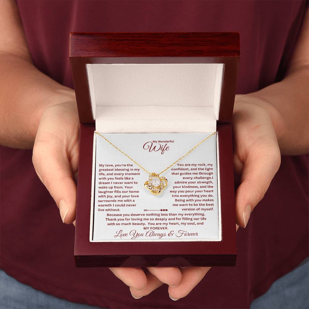 Hands holding Wife Gift with love knot necklace and special message in a luxury box