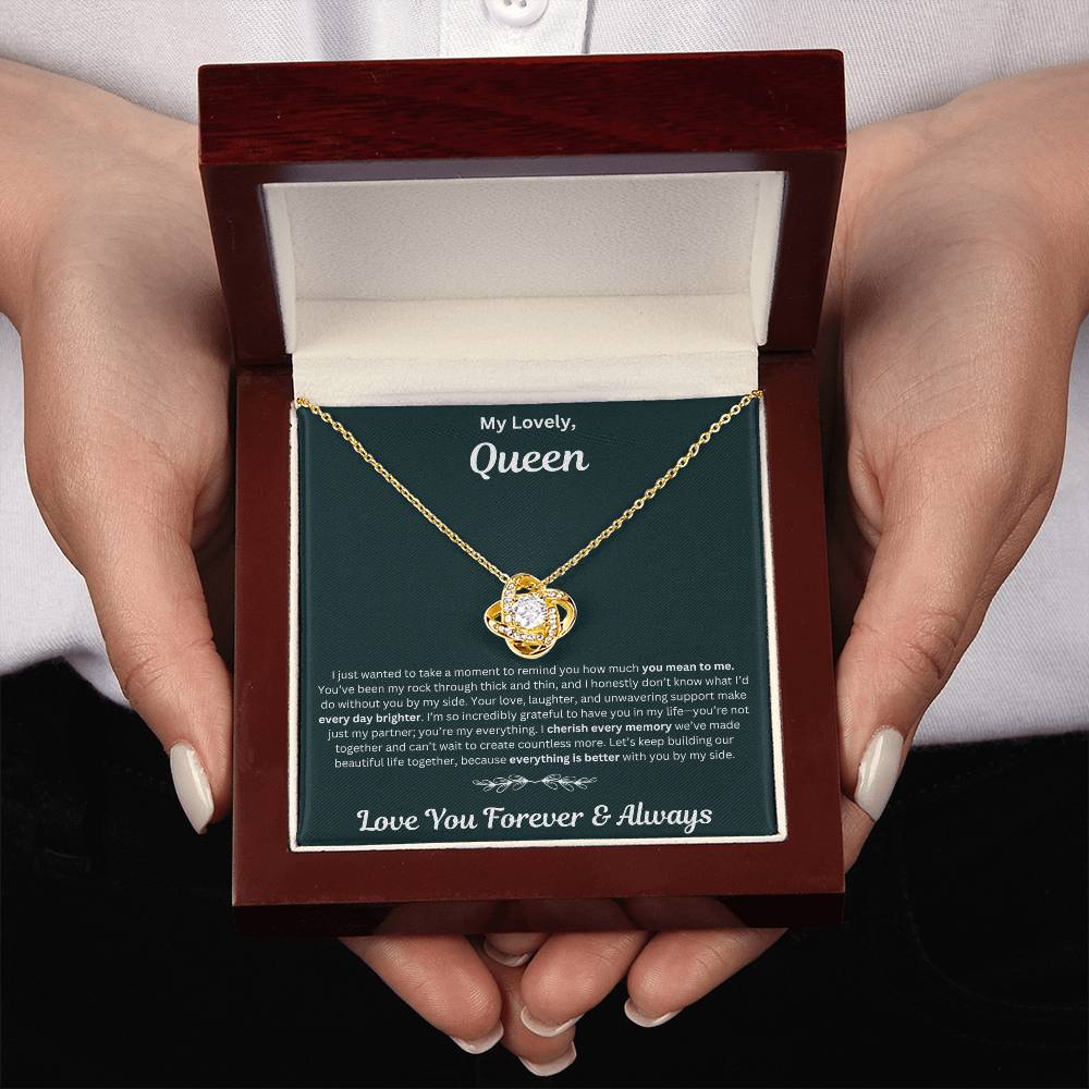 Hand holding Soulmate gift with love knot necklace and special necklace in luxury box