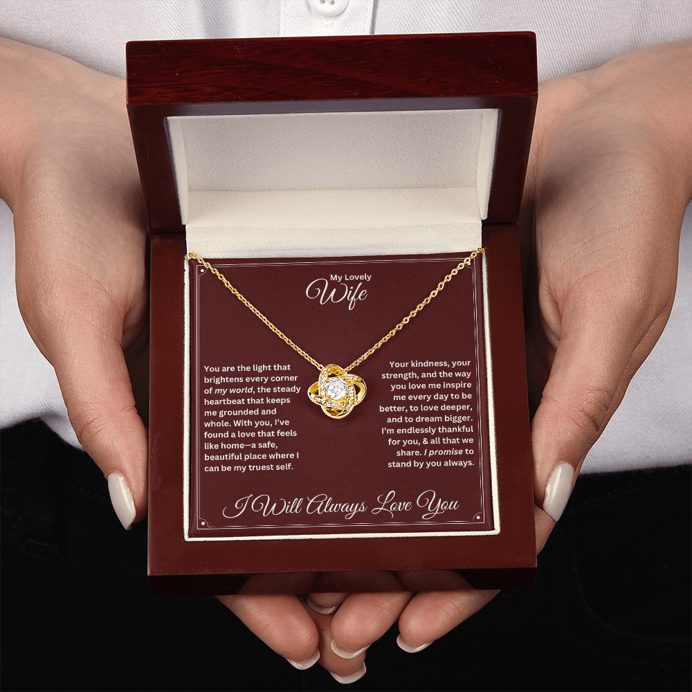 Hands holding the Wife gift with love knot necklace and special message in a luxury box