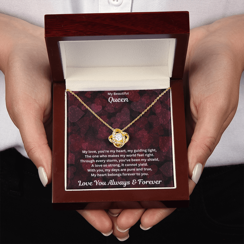 Hands holding the Soulmate gift with love knot necklace and special message in a luxury box