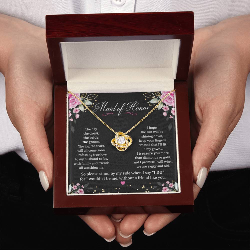 Two hands holding Maid Of Honor Gift With Love Knot Necklace With Message in Luxury box