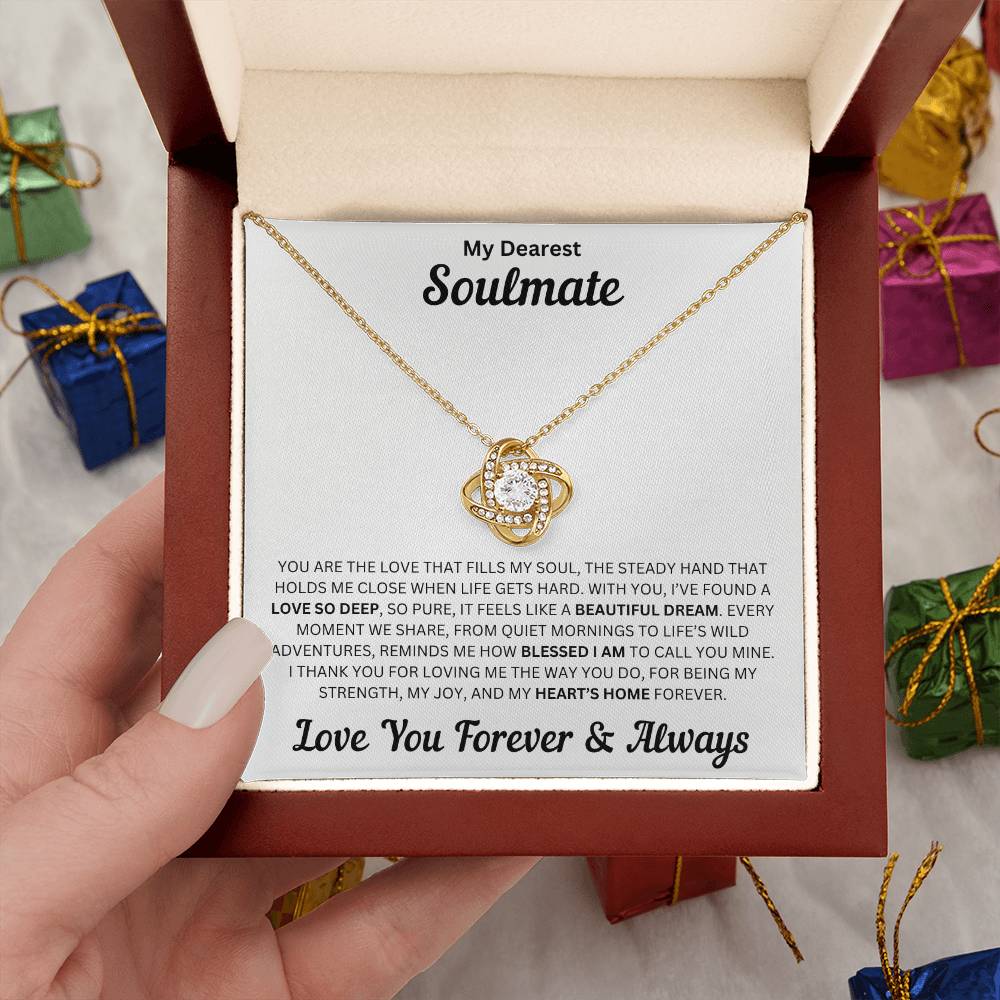 Hand holding Soulmate gift with love knot necklace and special message in a luxury box