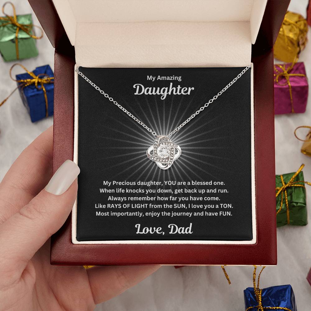 Hand holding the Daughter gift from dad with love not necklace and special sentiment in a luxury box