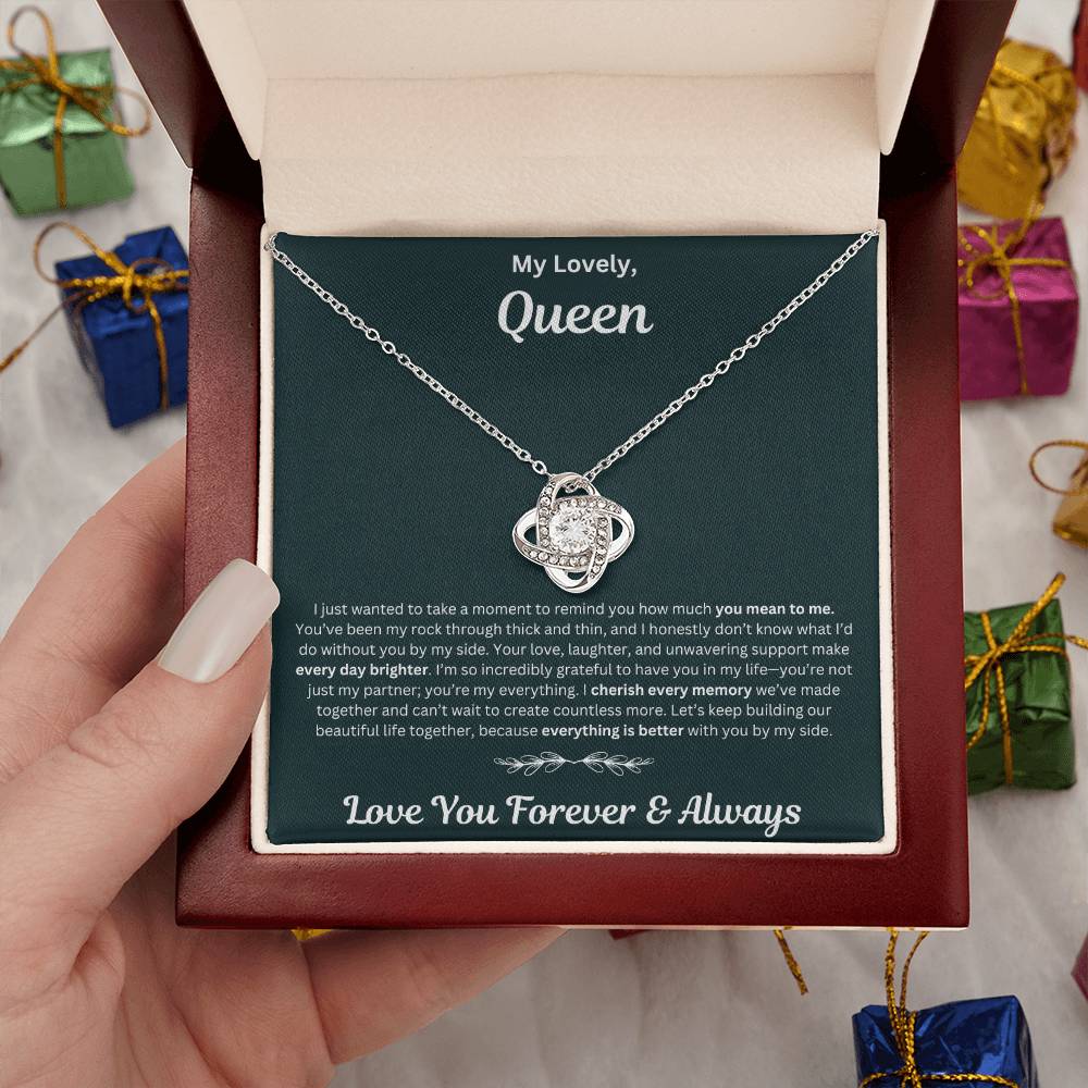 Hand holding Soulmate gift with love knot necklace and special necklace in luxury box