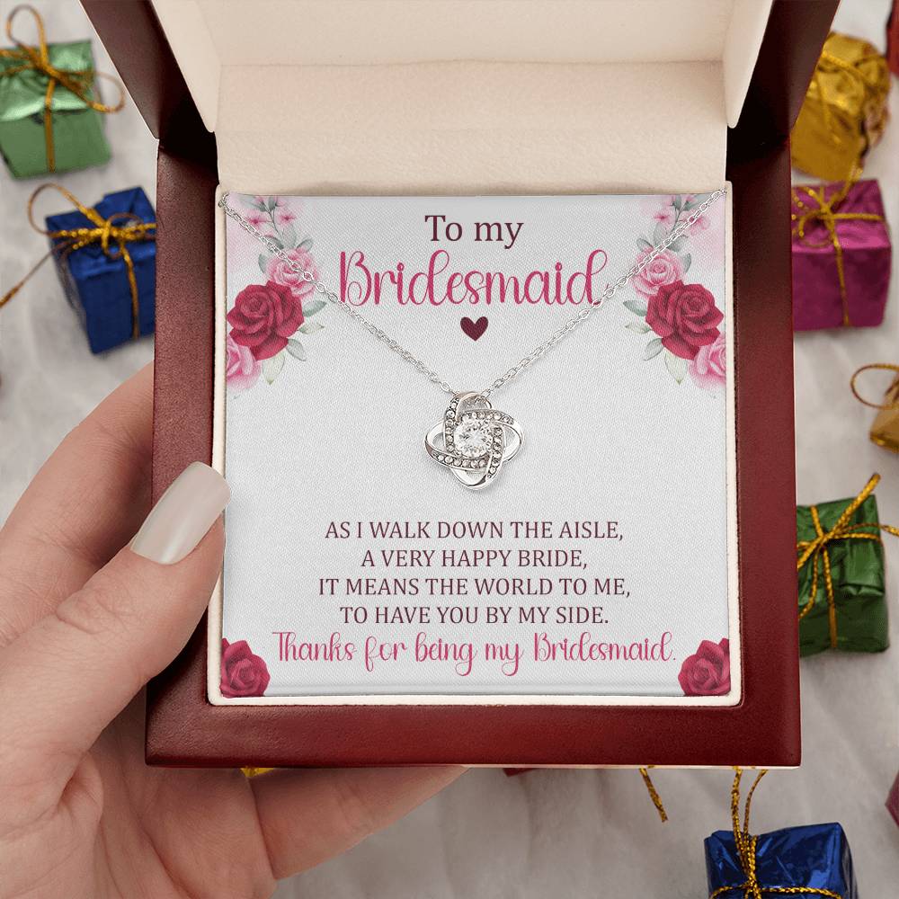 Hand holding Bridesmaid gift with love knot necklace and special message in ready to gift box