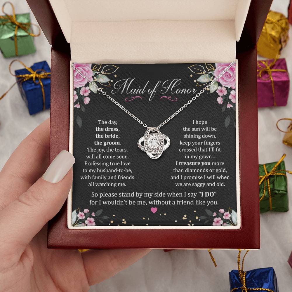 Hand holding Maid Of Honor Gift With Love Knot Necklace With Message in luxury box