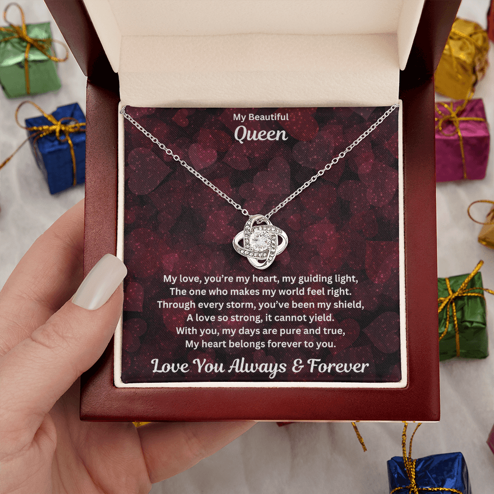 Hand holding Soulmate gift with love knot necklace and special message in a luxury box with props