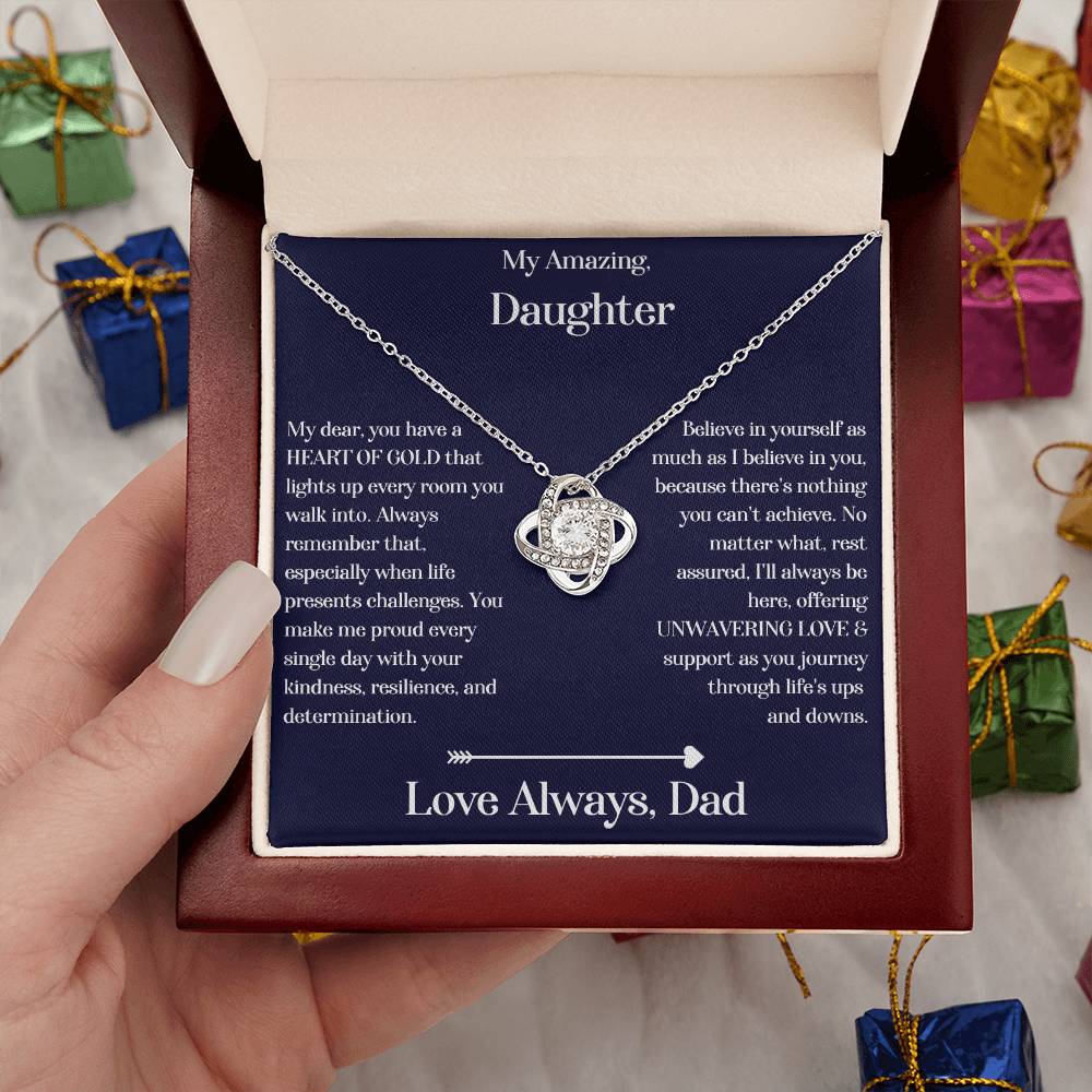 Hand holding Daughter gift from dad with love knot necklace and special sentiment in a luxury box