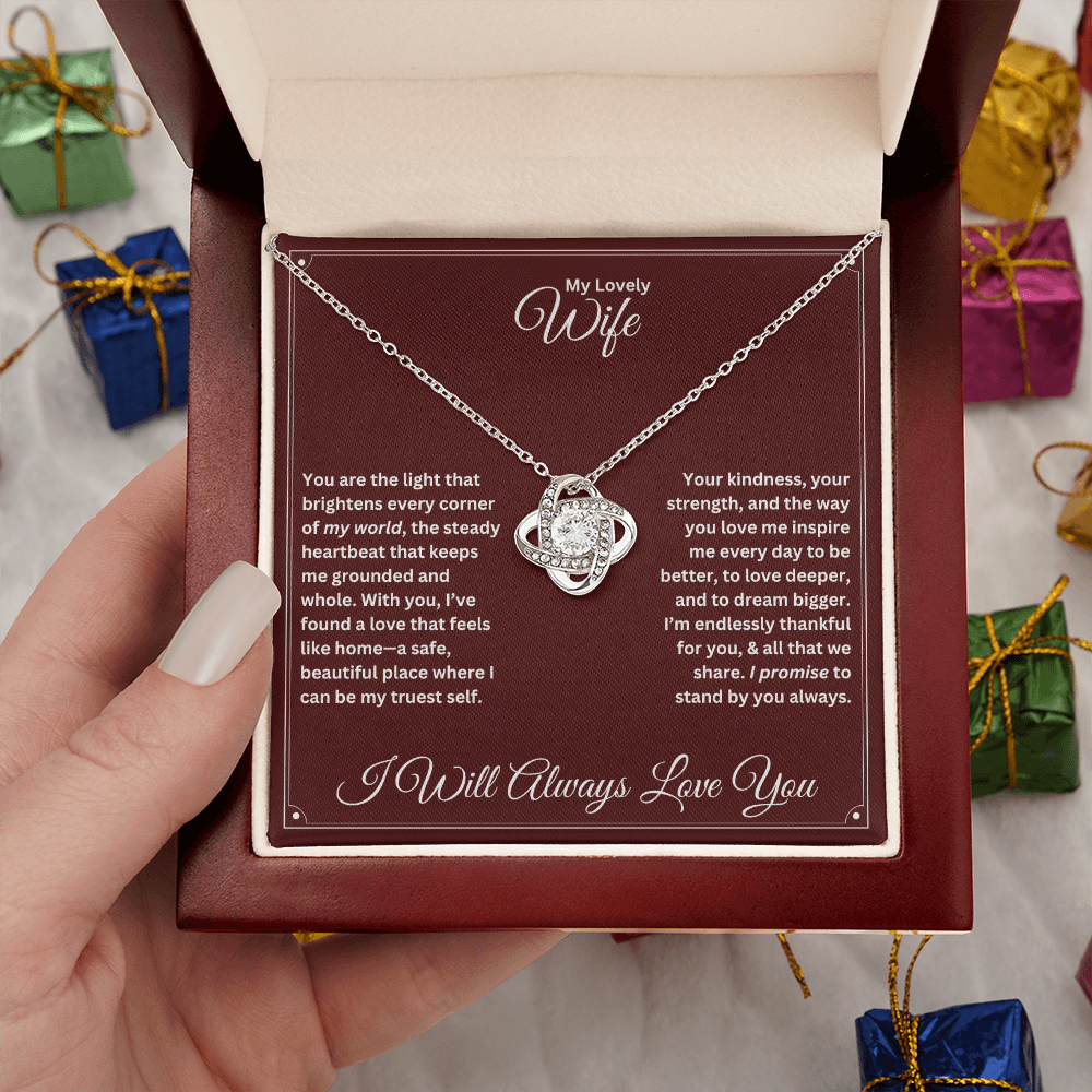 Hand holding Wife gift with love knot necklace and special message in a luxury box