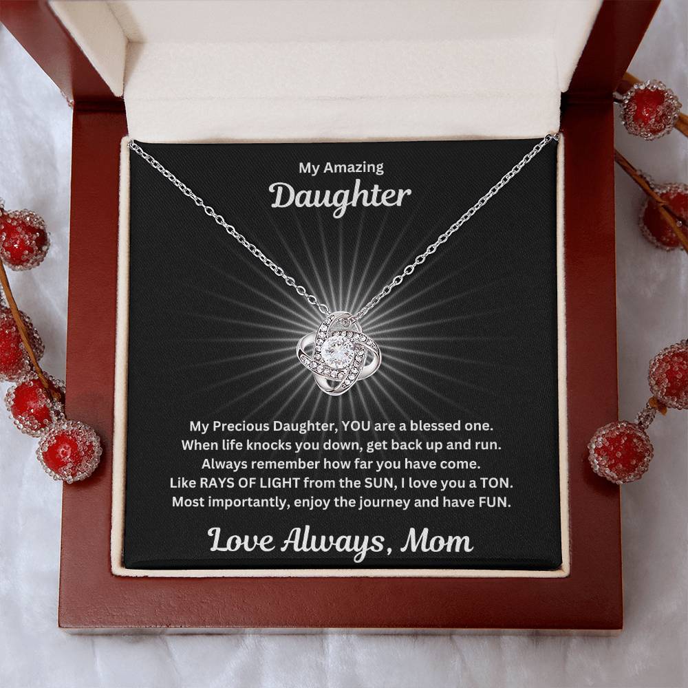 Daughter gift from mom with beautiful love knot necklace and special message in a luxury box with holiday props