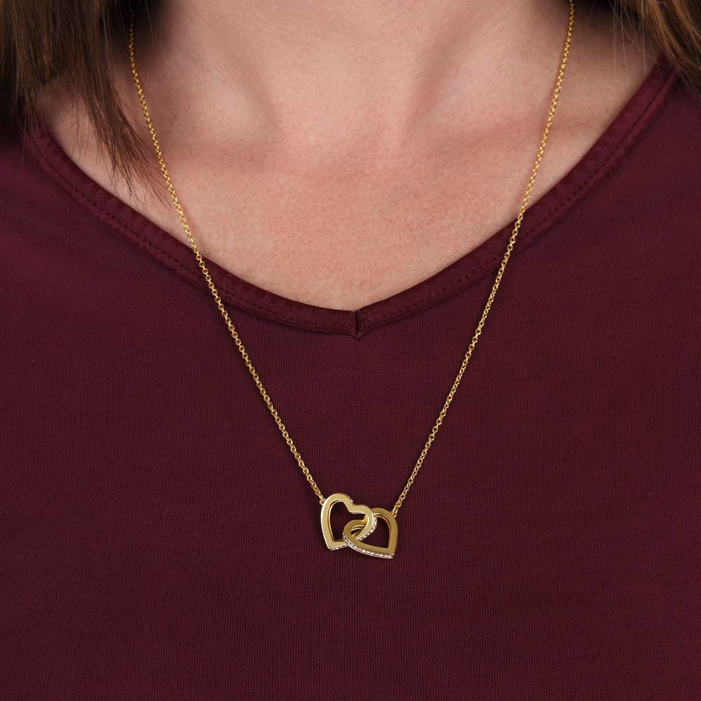 Person wearing the interlocking heart necklace