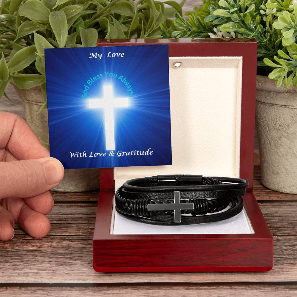 Hand Holding Message Card With Men's Cross Bracelet Placed In Luxury Box With LED Spotlight