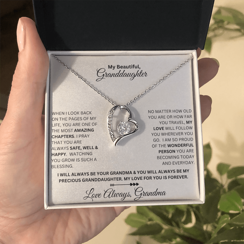 Hand holding Granddaughter gift from grandma with forever love necklace and special sentiment in a standard box