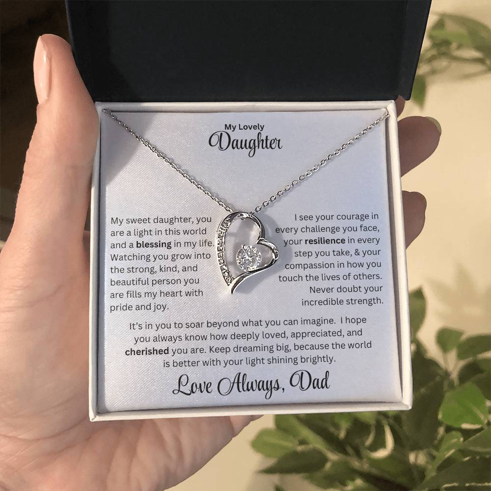 Hand holding daughter gift with forever love necklace and special message in standard box