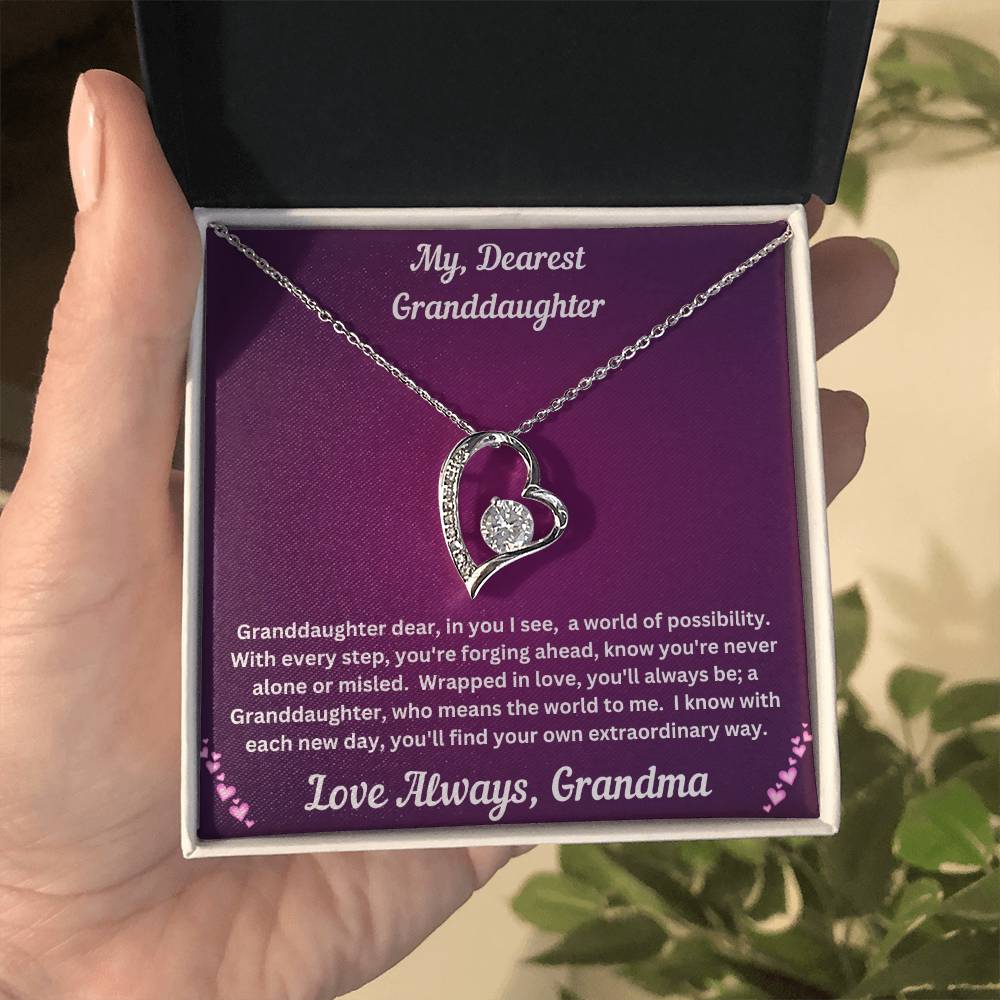 Hand holding Granddaughter gift from grandma with forever love necklace and special message in two tone box